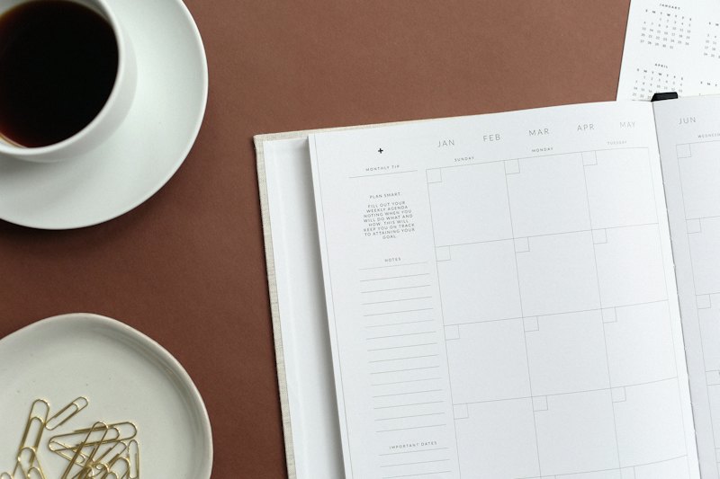 Open notebook and teacup on a table