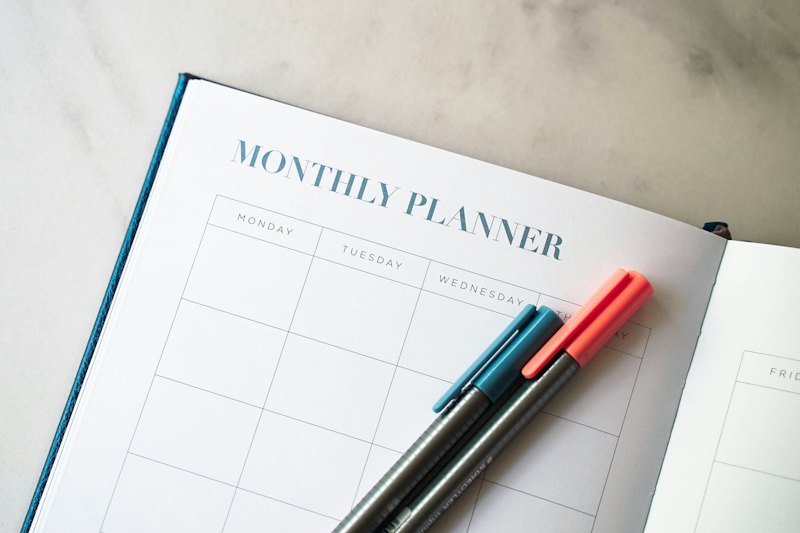 Planner notebook with pens on a desk