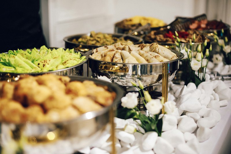 Buffet table with chafing dishes and flowers